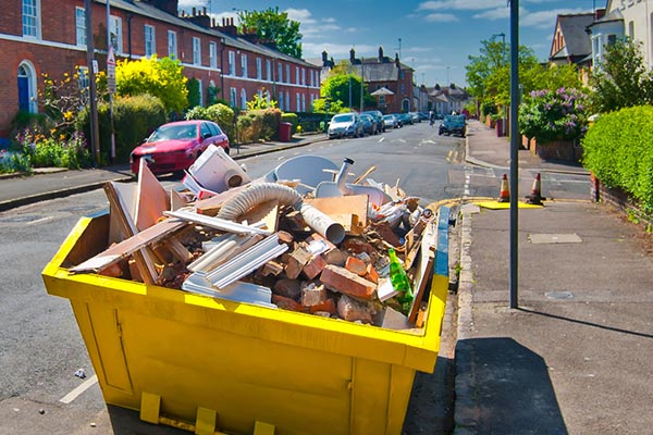 Large Yellow Trash Bin full of junk